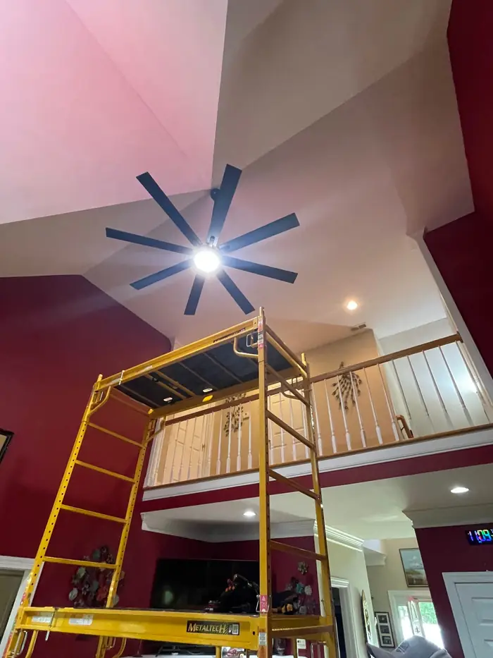 Ceiling fan installed at the top of a two story room with the scaffolding still up