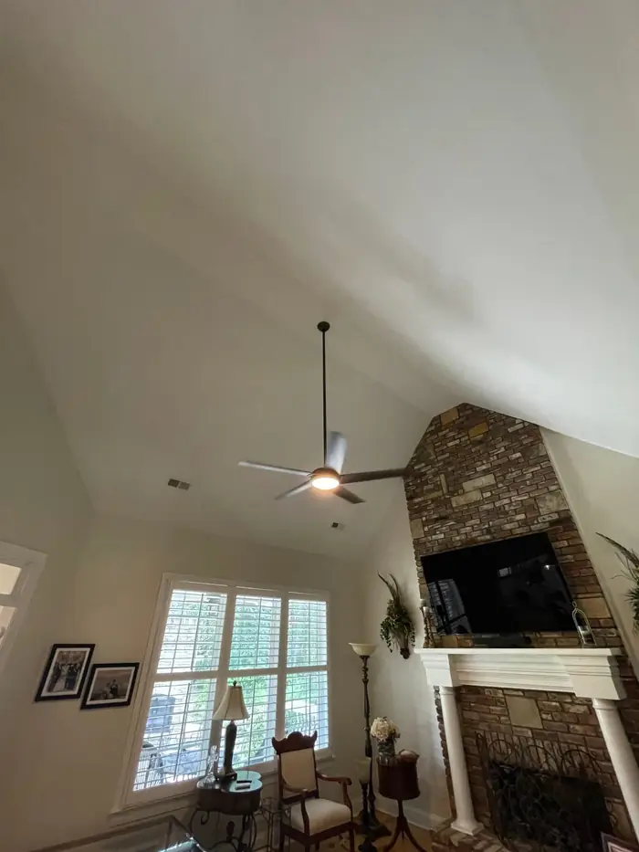 Ceiling fan hung from a vaulted ceiling in a living room