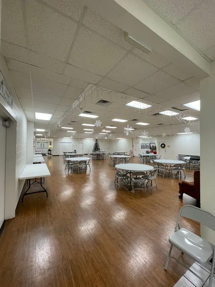 Recessed ceiling lighting lit across a large meeting hall